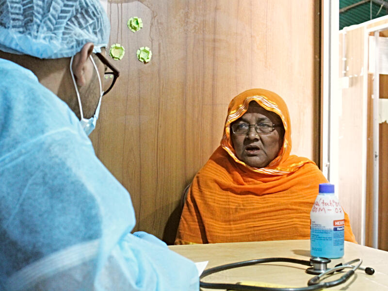 Ambia, a 60-year-old Rohingya refugee came to the International Rescue Committee enter with other health issues but had many questions about COVID-19. At the IRC health center in Cox's Bazar, Dr. Muhaiminur speaks with Ambia, a 60-year-old refugee