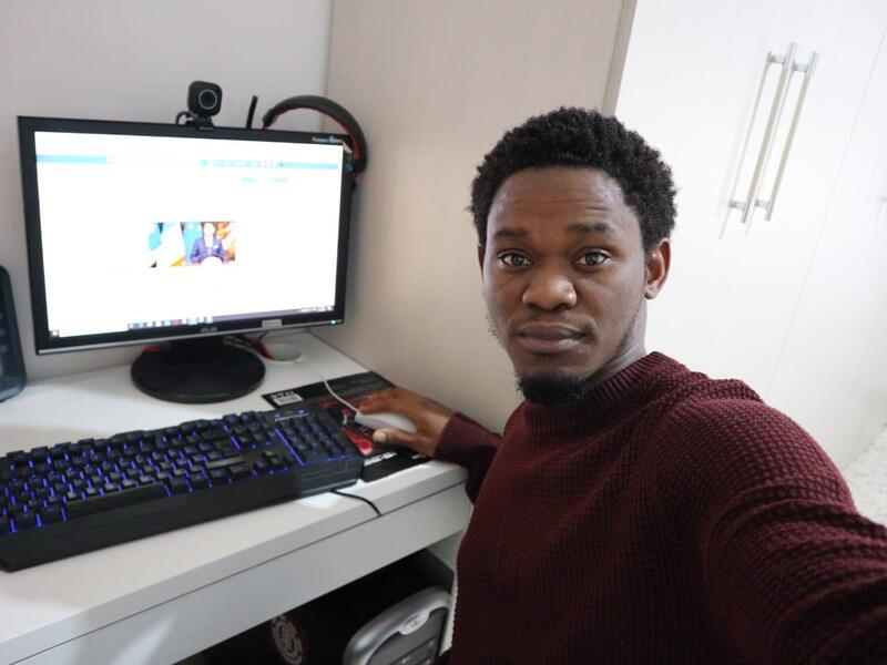 Refugee.Info moderator Henry at his home computer