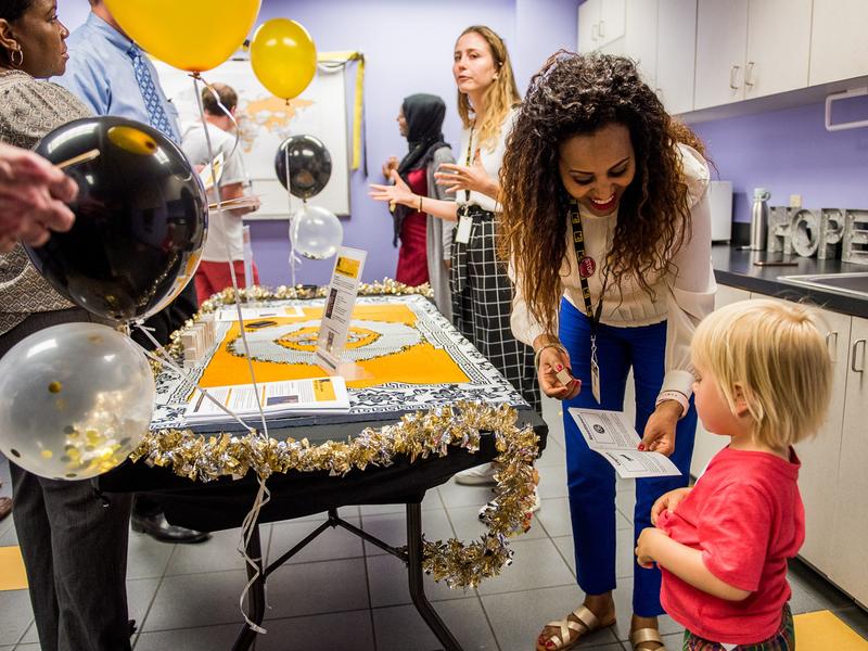 A tiny attendee gets their passport stamp from IRC Resettlment Manager, Birtukan Assefa! A tiny attendee gets their passport stamp from IRC Resettlment Manager, Birtukan Assefa!