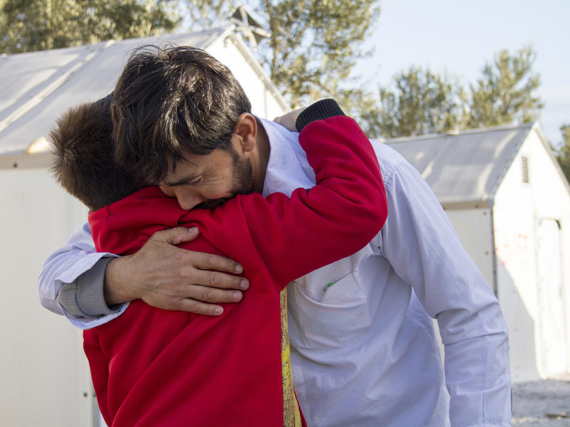 Mohammed hugs his son Afghan refugee father is reunited with his son.