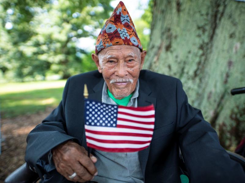 A man holds an American flag. A man holds an American flag.