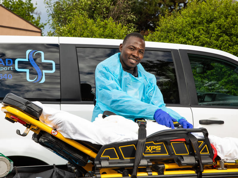 Jonathan Amissa stands in front of a van he uses for his medical transport company. Jonathan Amissa stands in front of a van he uses for his medical transport company.