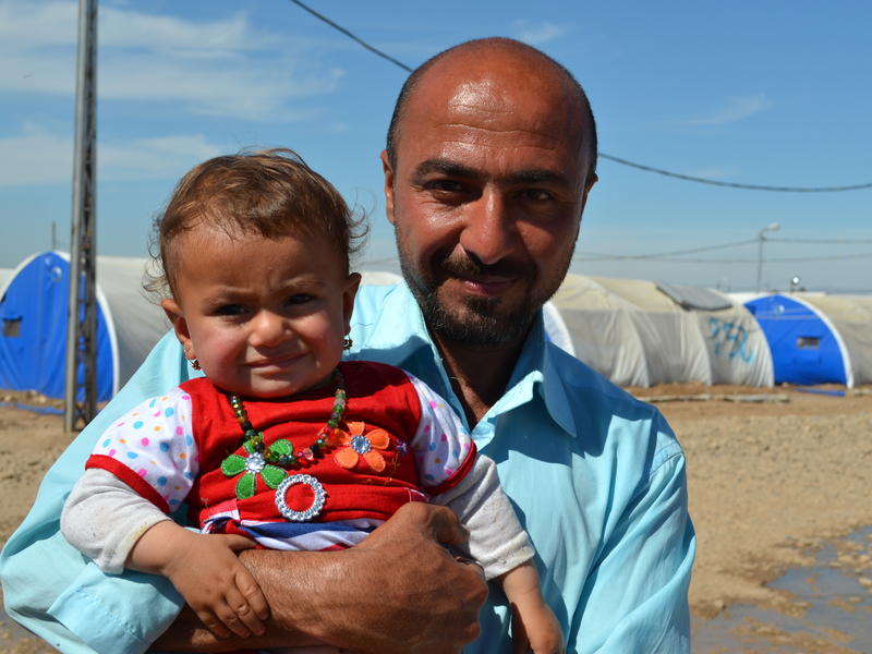 Omar and his baby daughter Amira fled to the Hammam al Alil displacement camp