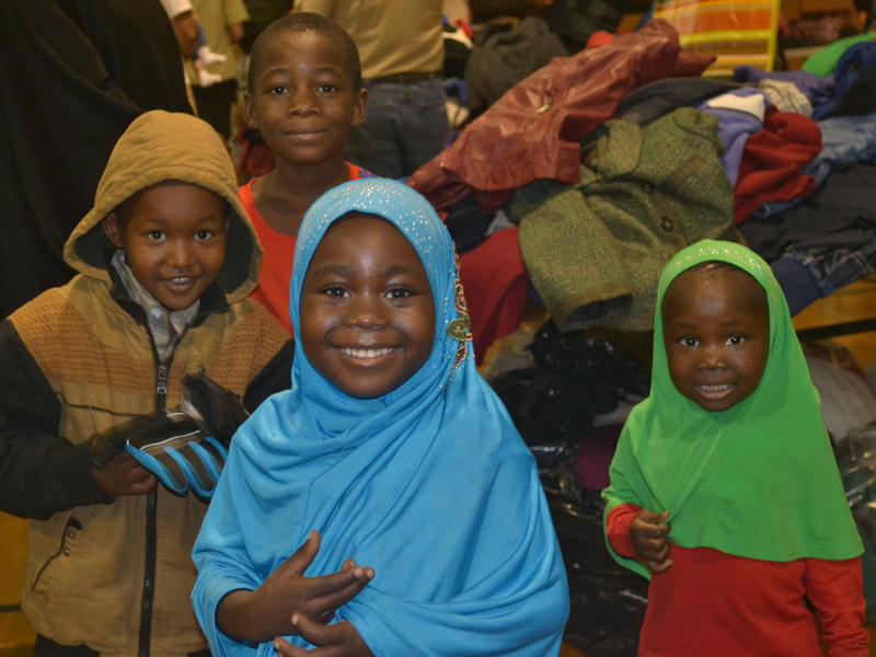 Four refugee children pick out winter clothing items at the 2016 Winter Clothing Drive in Salt Lake City