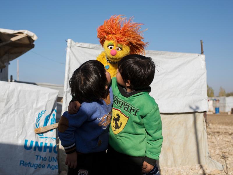 Syrian boys play with Sesame Street Muppet Tonton Syrian boys play with Sesame Street Muppet Tonton