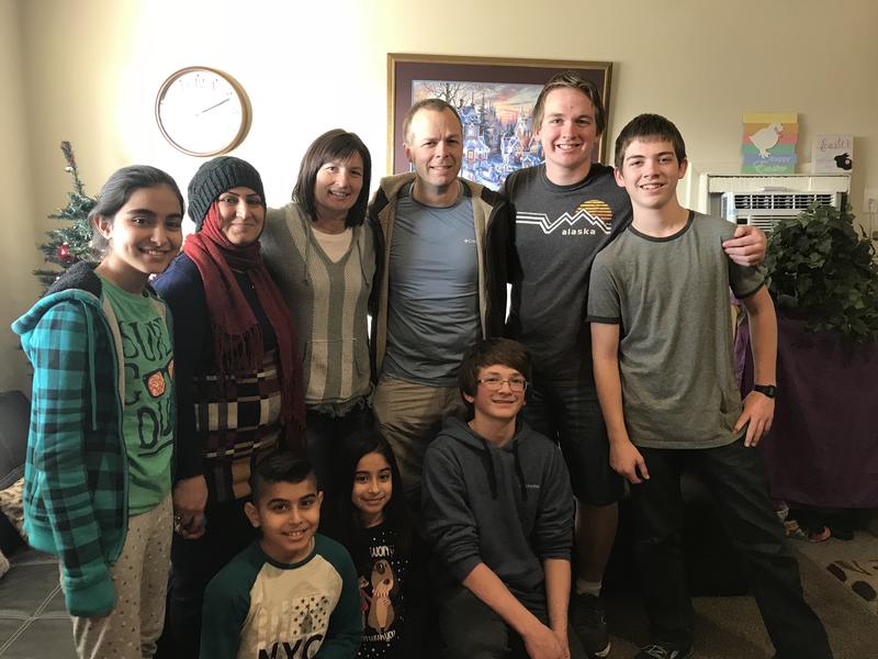 Refugee families become hopeless due to the travel ban. Refugee family stands with Light One Candle sponsor family.