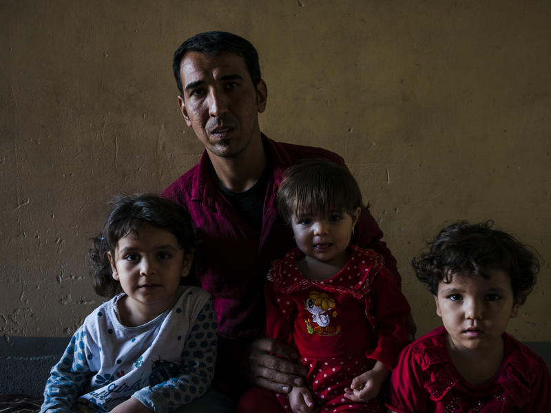 Iraqi father inside Mosul with his children Iraqi father inside Mosul with his children