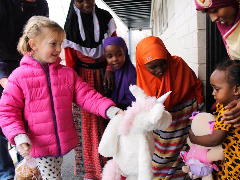 Community members in Utah visit refugee families with gifts for the holidays.