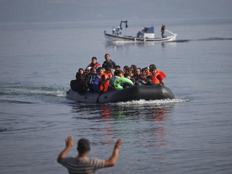 Refugees and migrants arrive on the Greek island of Lesbos in a rubber raft Refugees and migrantsapproach the coast of the Greek island of Lesbos in a crowded rubber raft
