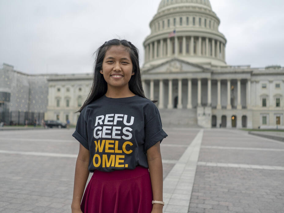 Nuam San, a member of the IRC's Refugee Voices program, travels to Washington, DC, to advocate for her fellow refugees. Nuam San, wearing a shirt that says Refugees Welcome, stands in front of the U.S. Capitol building.