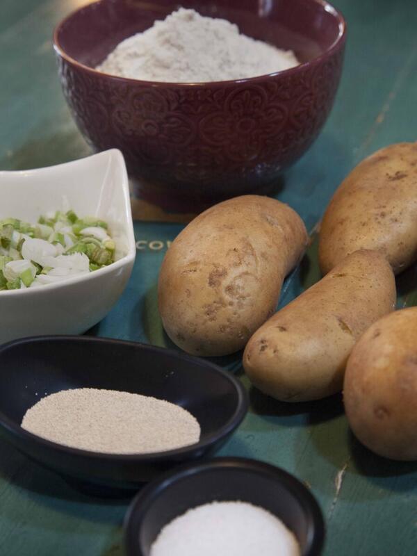Ingredients for Afghan Bolani Ingredients for Afghan Bolani arranged a on a table with a green tablecloth. They include potatoes and salt.