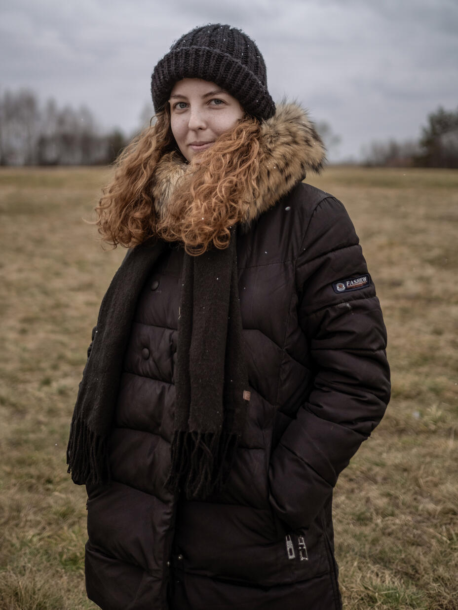 Anastasia stands on the border between Ukraine and Poland