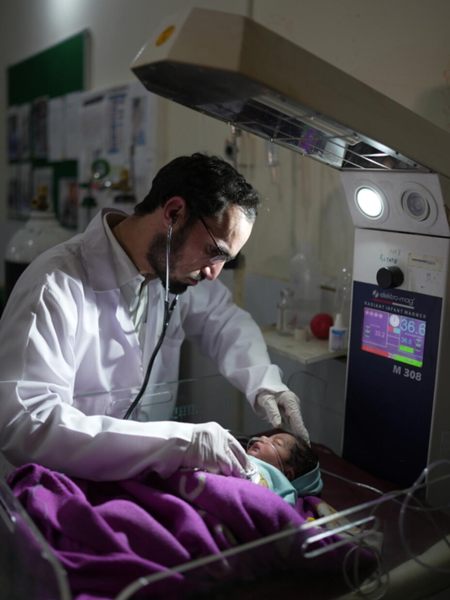 Dr. Mujahid does a health check-up on a newborn baby