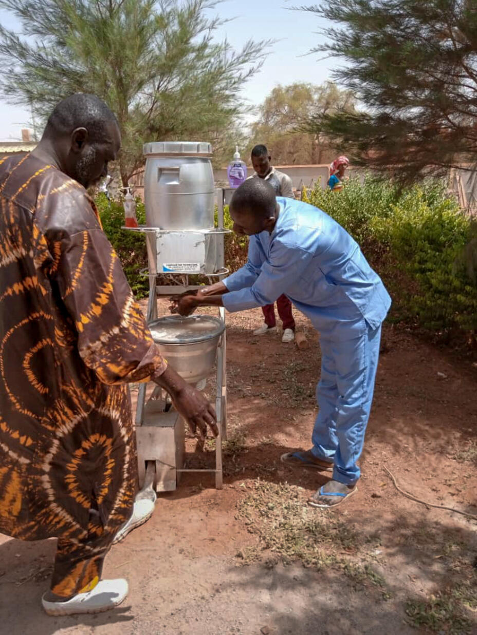 Health workers, with IRC support, screen for symptoms of coronavirus at a health center in Djibo, Burkina Faso.