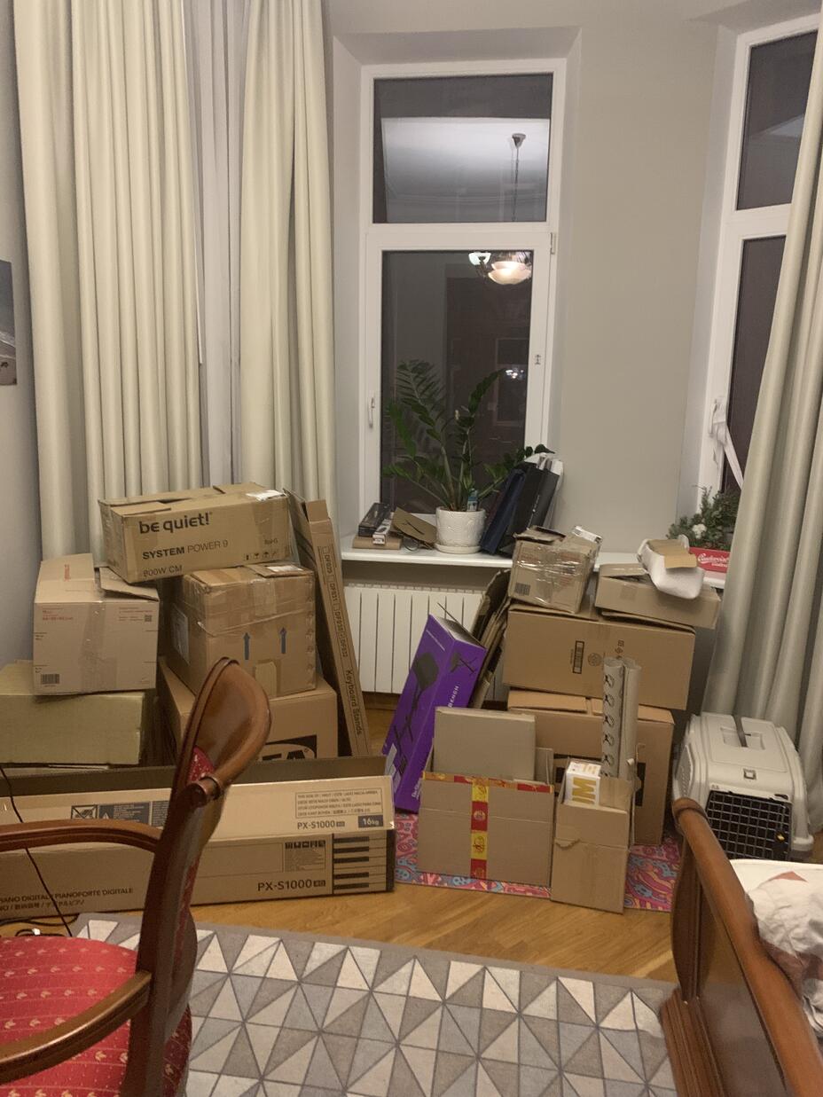 A flat with boxes piled by a window
