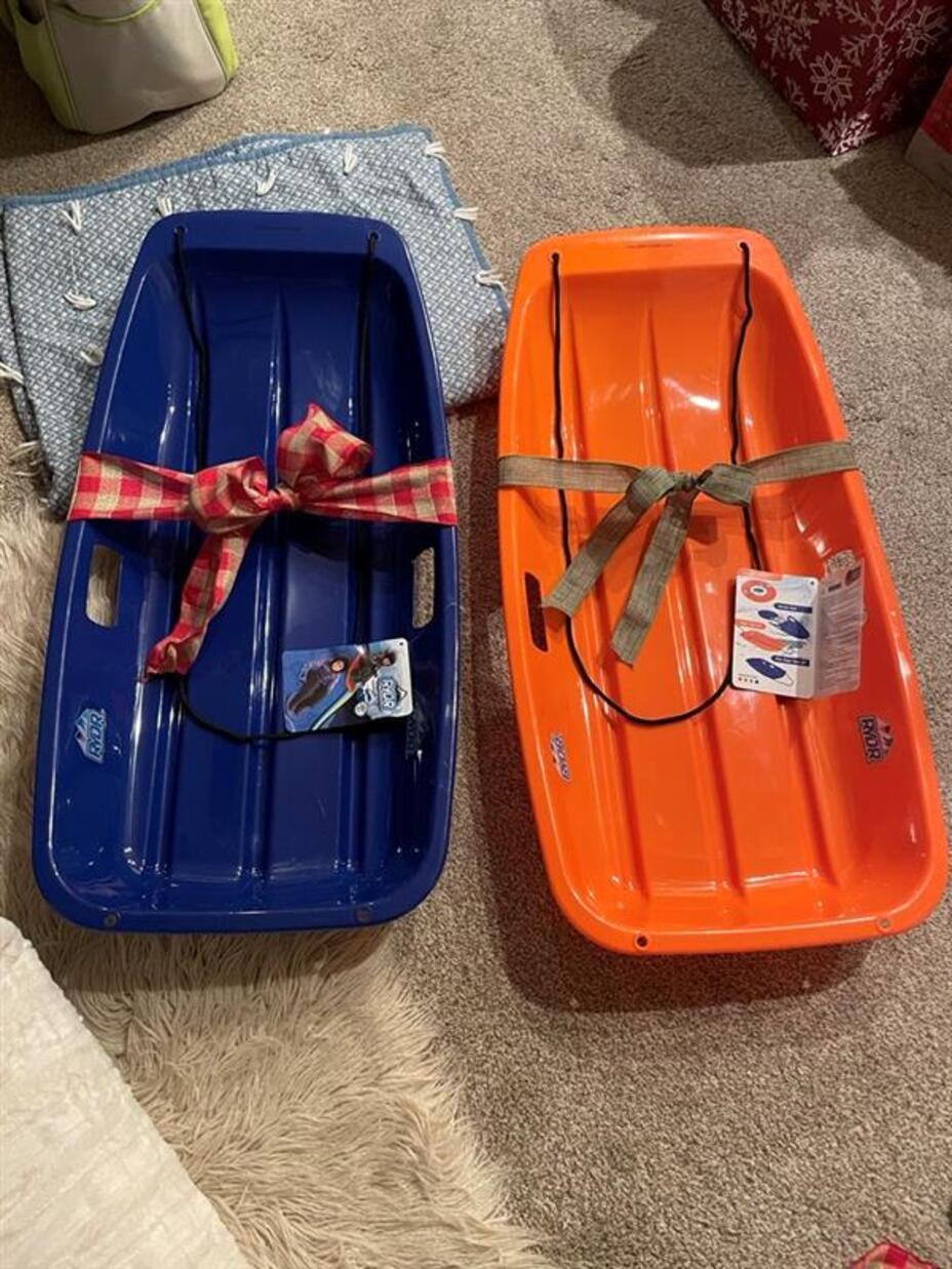 Two sleds wrapped in bows.