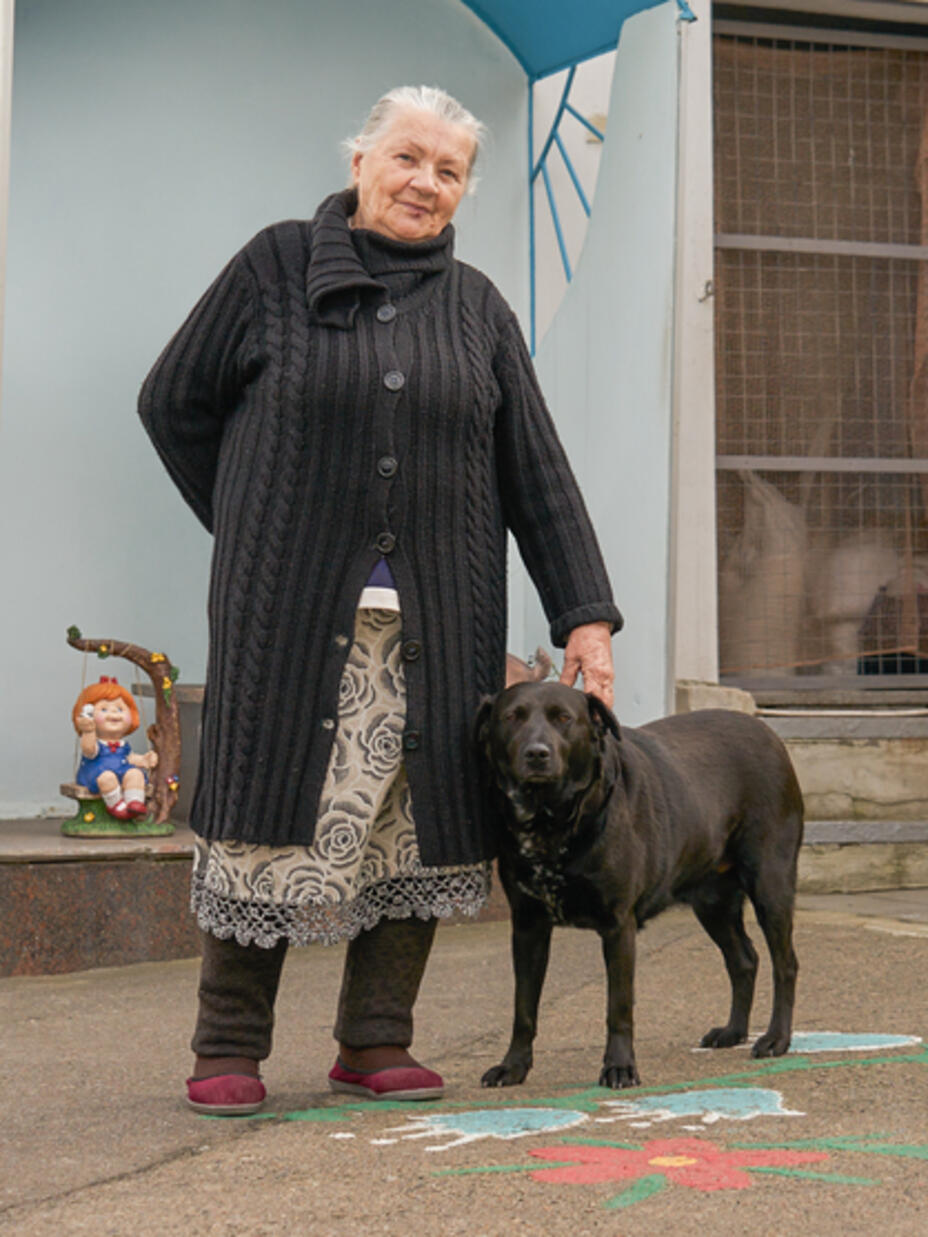 Alla standing outside with her dog Nika