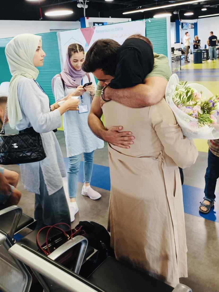 At the airport in Rome Ozair and his family welcomes his father, reuniting the family at last.