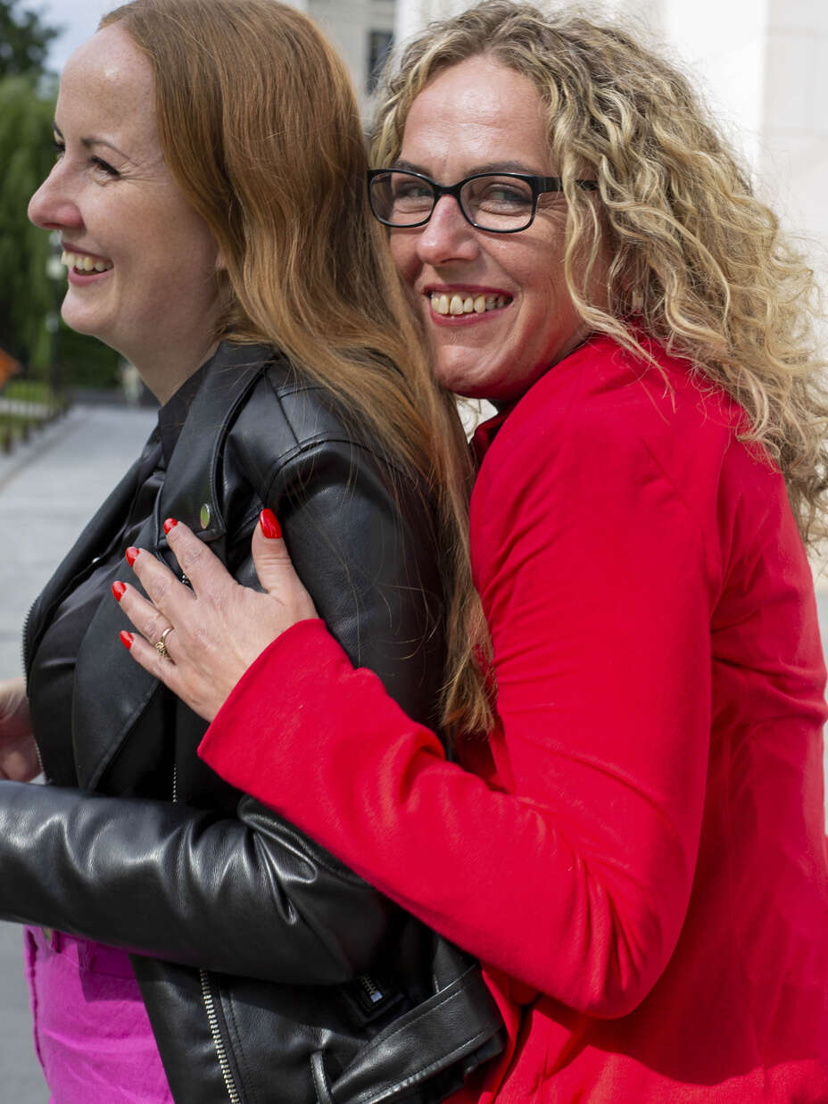 The two friends hug each other.