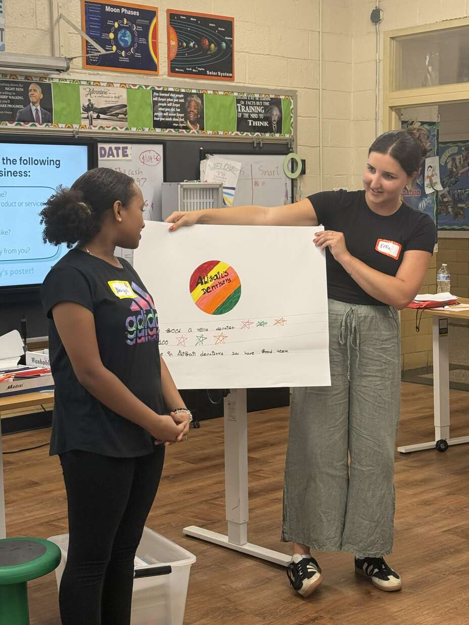 IRC staff doing an activity at summer academy in class.