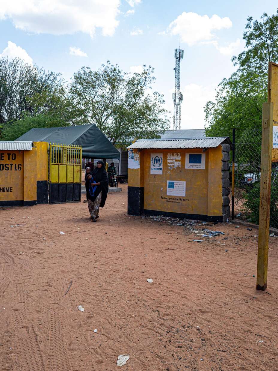 A woman walks out of the health centre after schedules vaccinations for her children. 