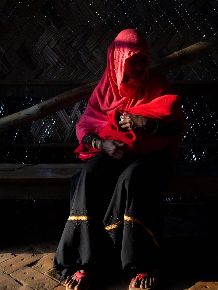 A woman holds her baby in Cox’s Bazar refugee camp in Bangladesh, where there is high rates of violence against women.