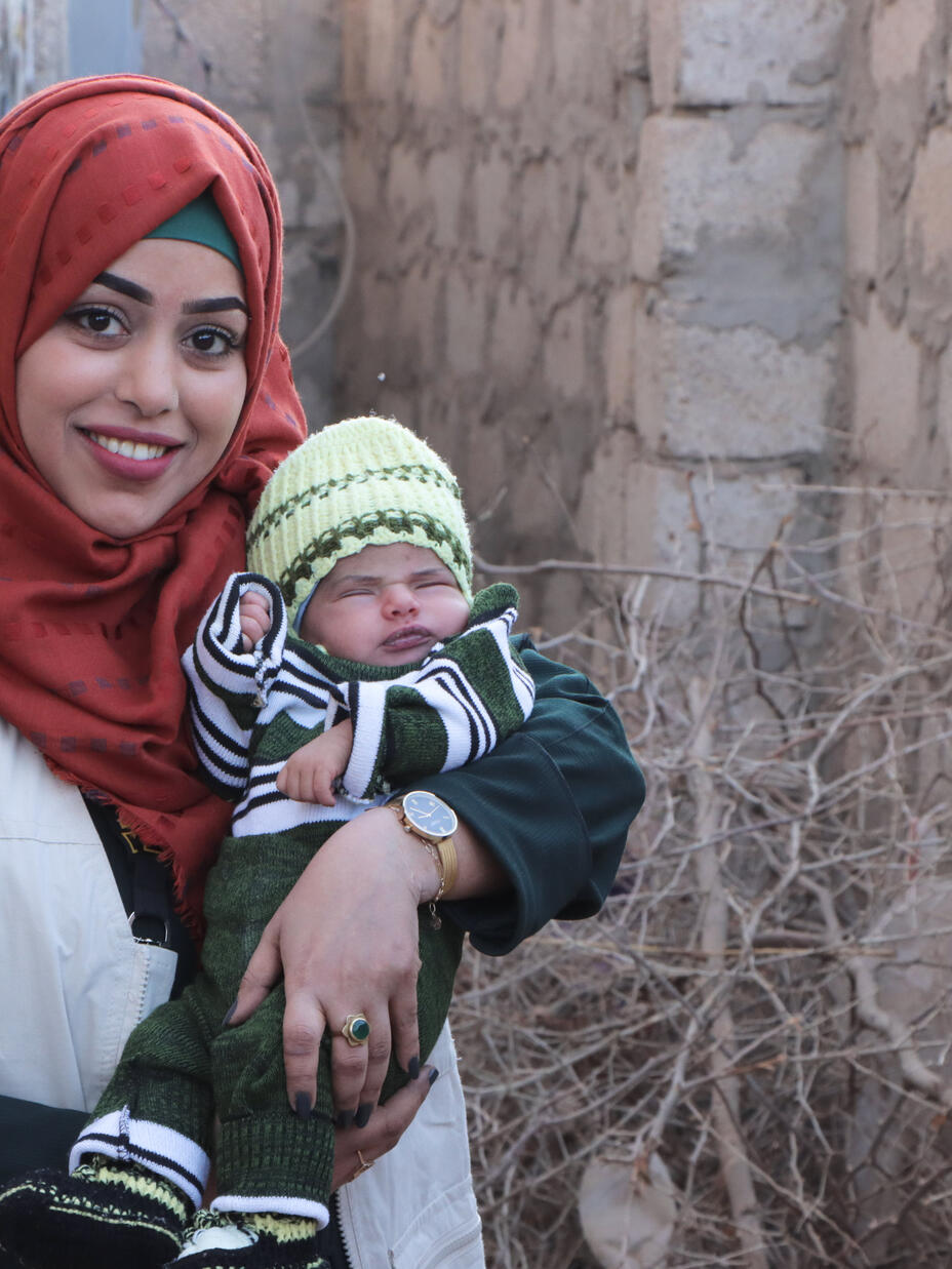 Bushra holding an infant