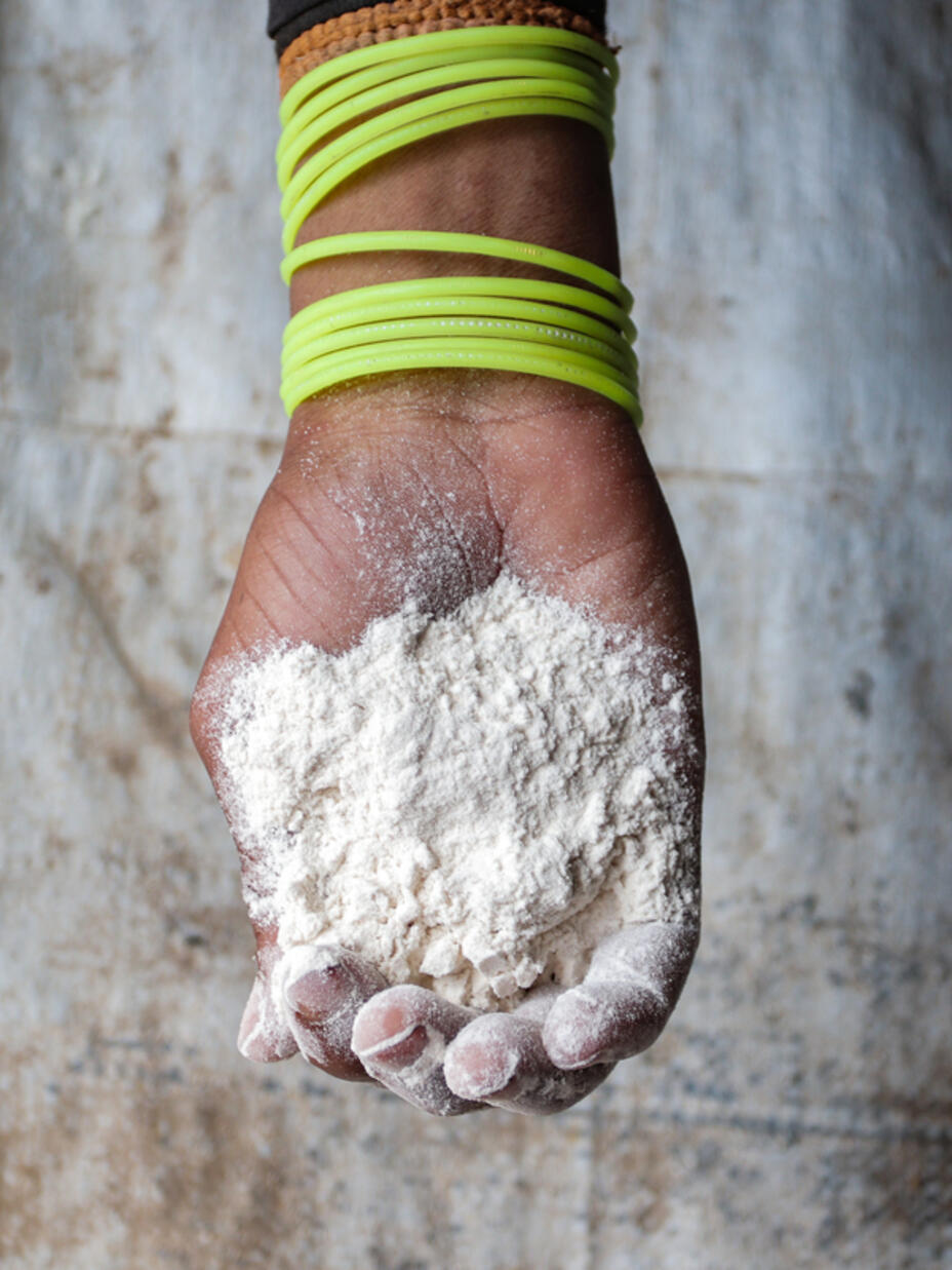 A hand holding flour