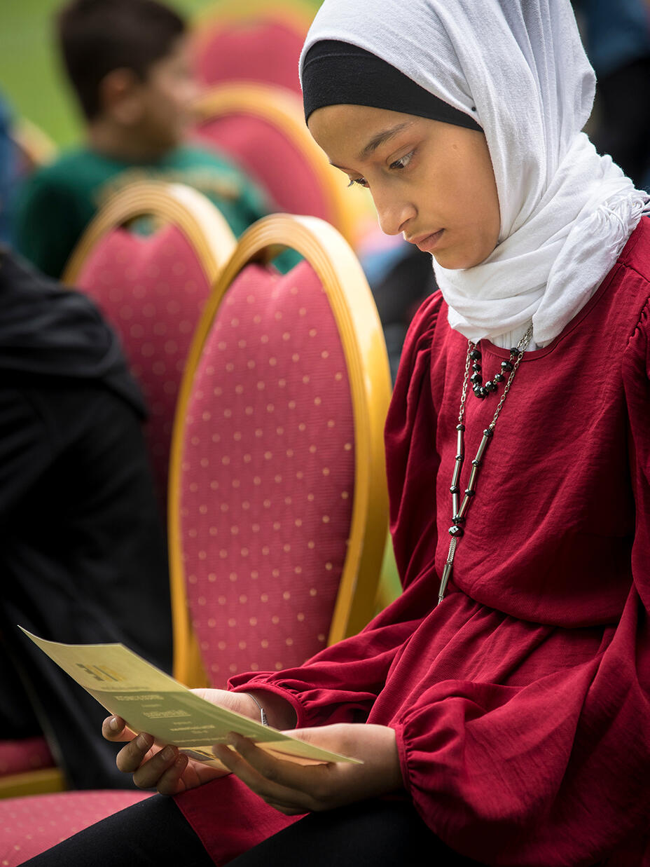 Sidra looks at her father Khalil’s graduation certificate. 