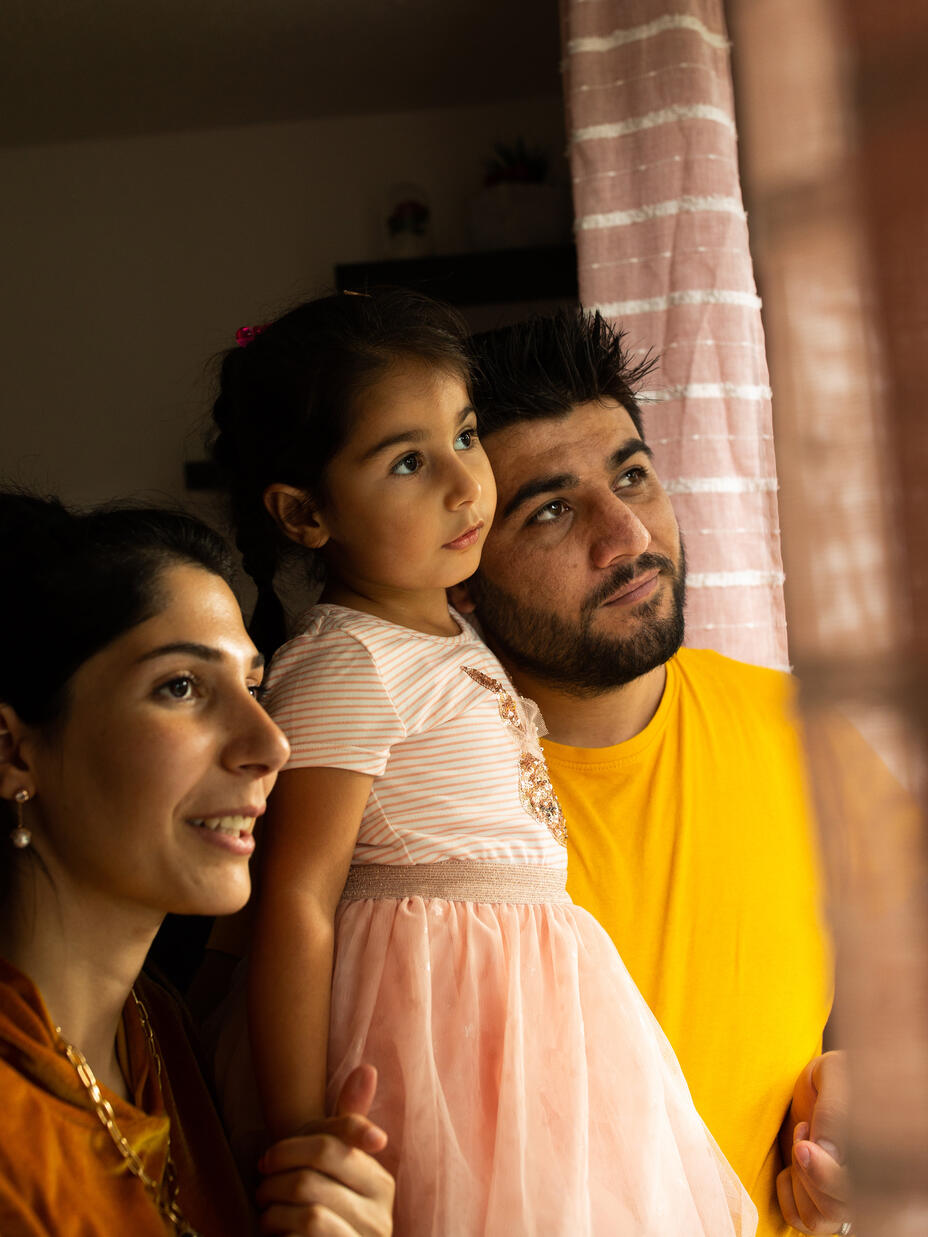 Maasom, Hiba and Nasrin look out the window together of their home in Hampshire.