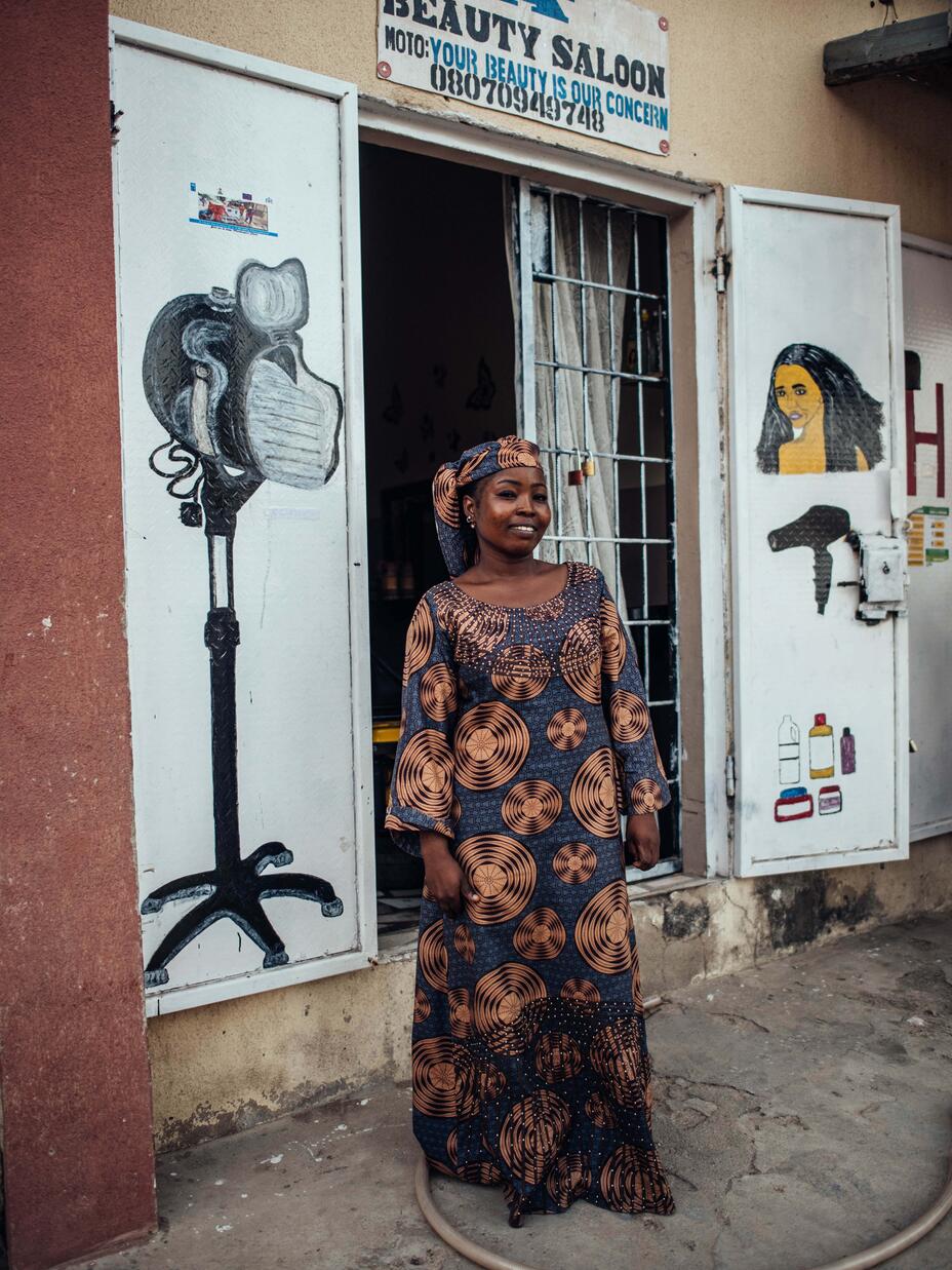 Abigail stands outside her salon.