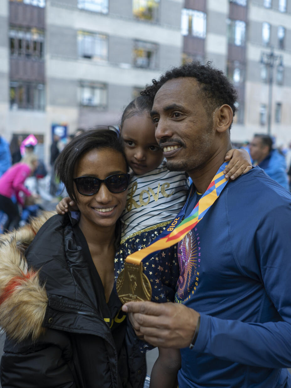 Tolassa Elemaa and his wife Bikiltu hold their daughter in Manhattan after the 2018 NYC Marathon