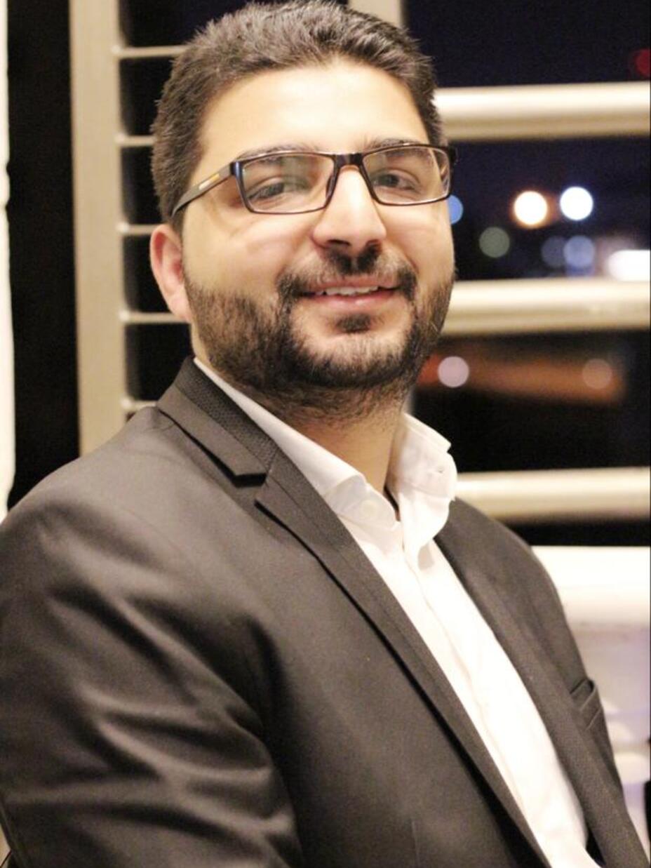 Dr. Abedalhaleem Albalasmeh, wearing a suit, smiles for the camera.