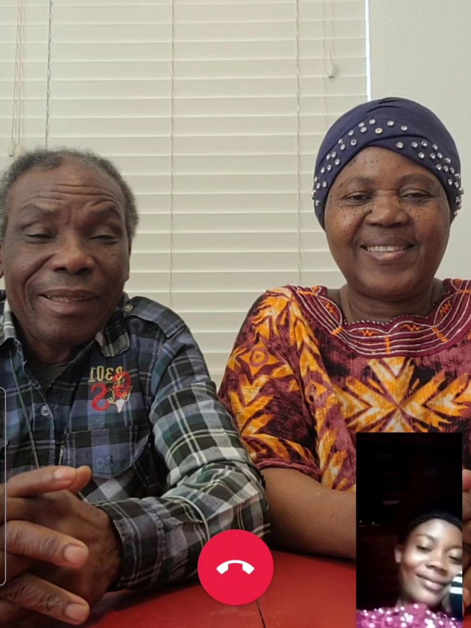 A screenshot of a smart phone, with Patrice and his wife sitting at a table and their daughter Mauwa in a small box on the lower right side of the screen