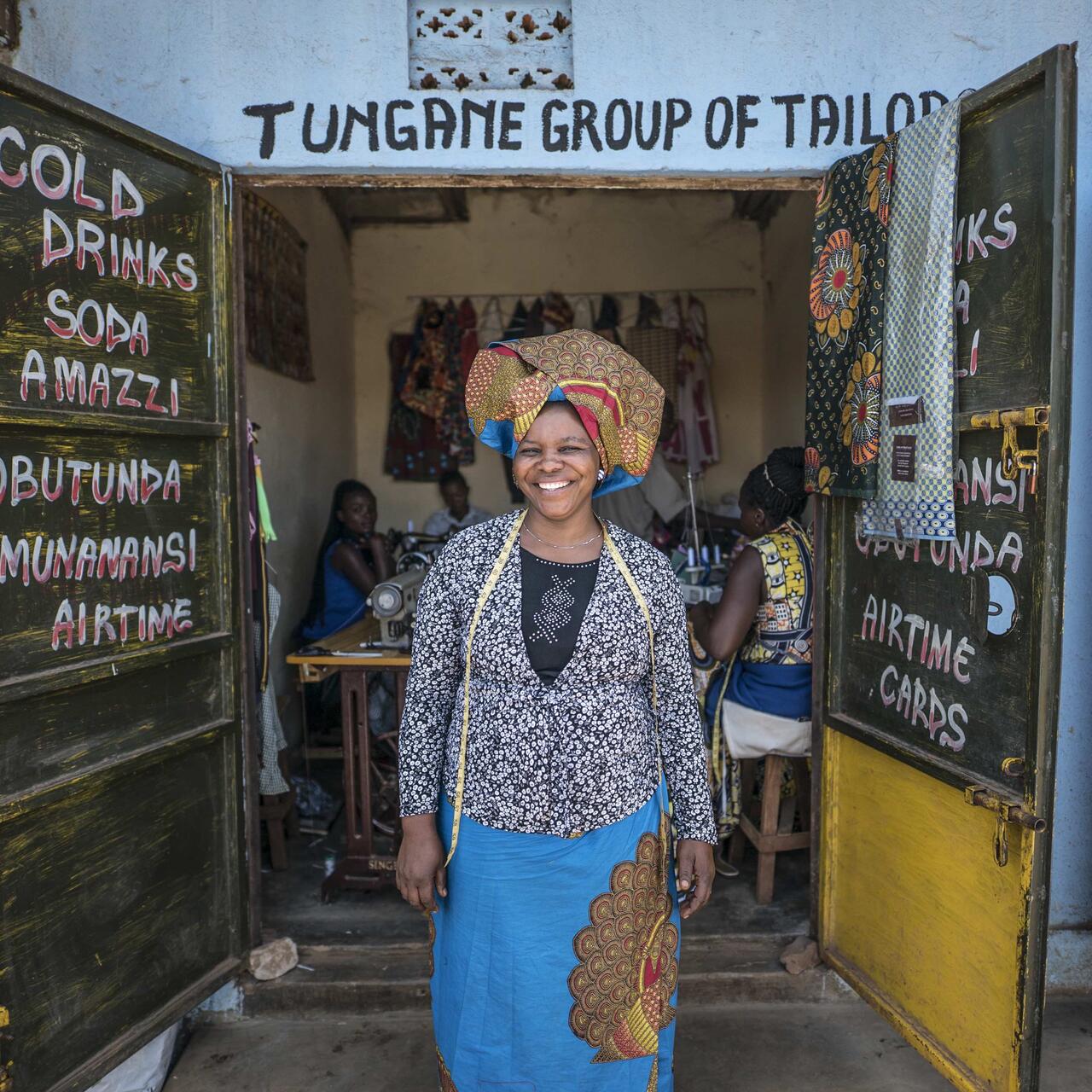 Woman standing in the doorway of Tungane Group of Tailors.