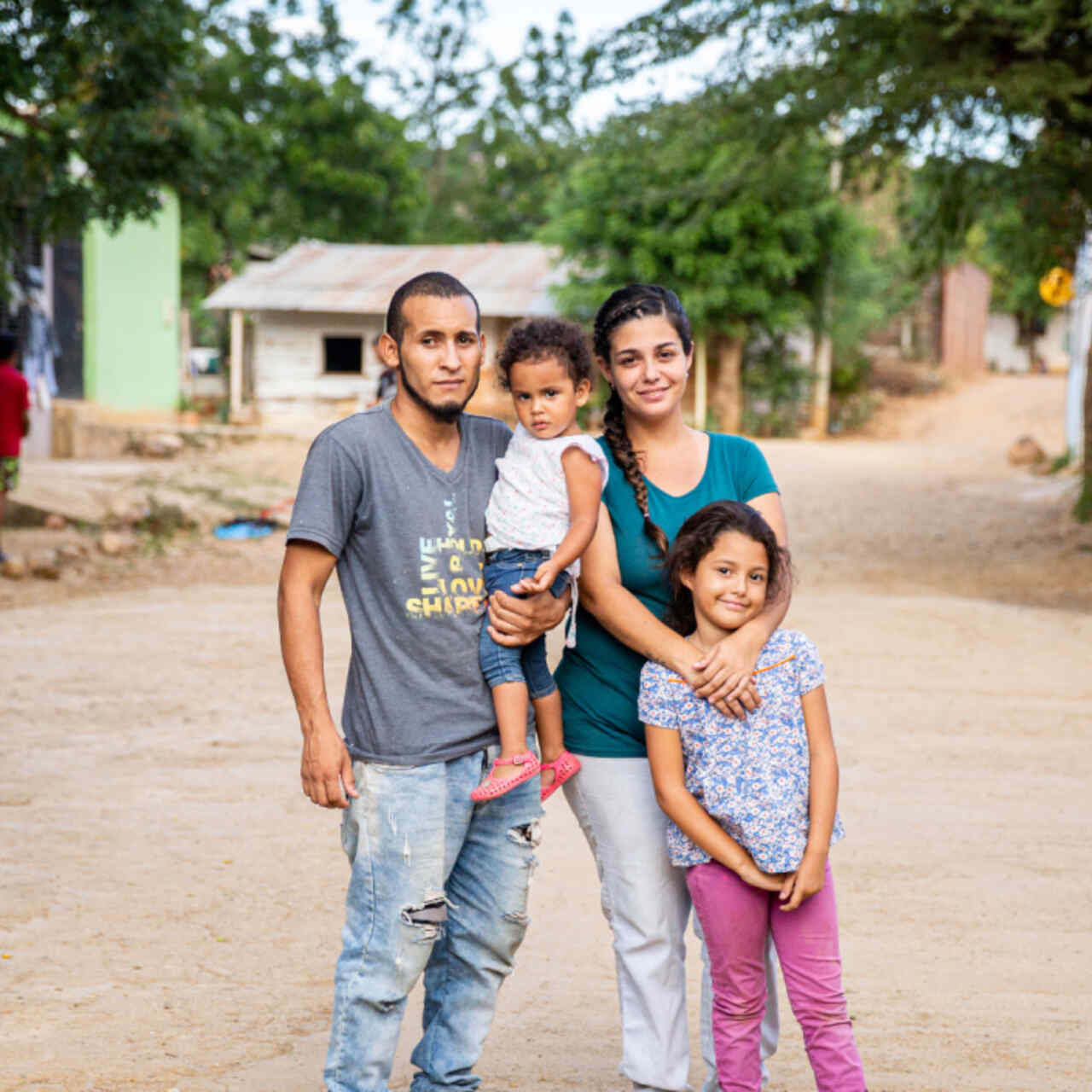 A family stands in the middle of a road