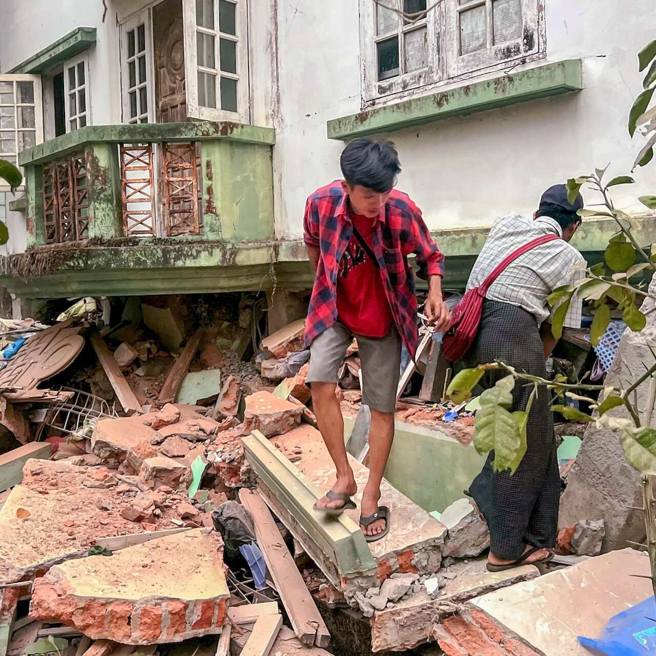 Man walking through rubble after earthquake strikes Myanmar
