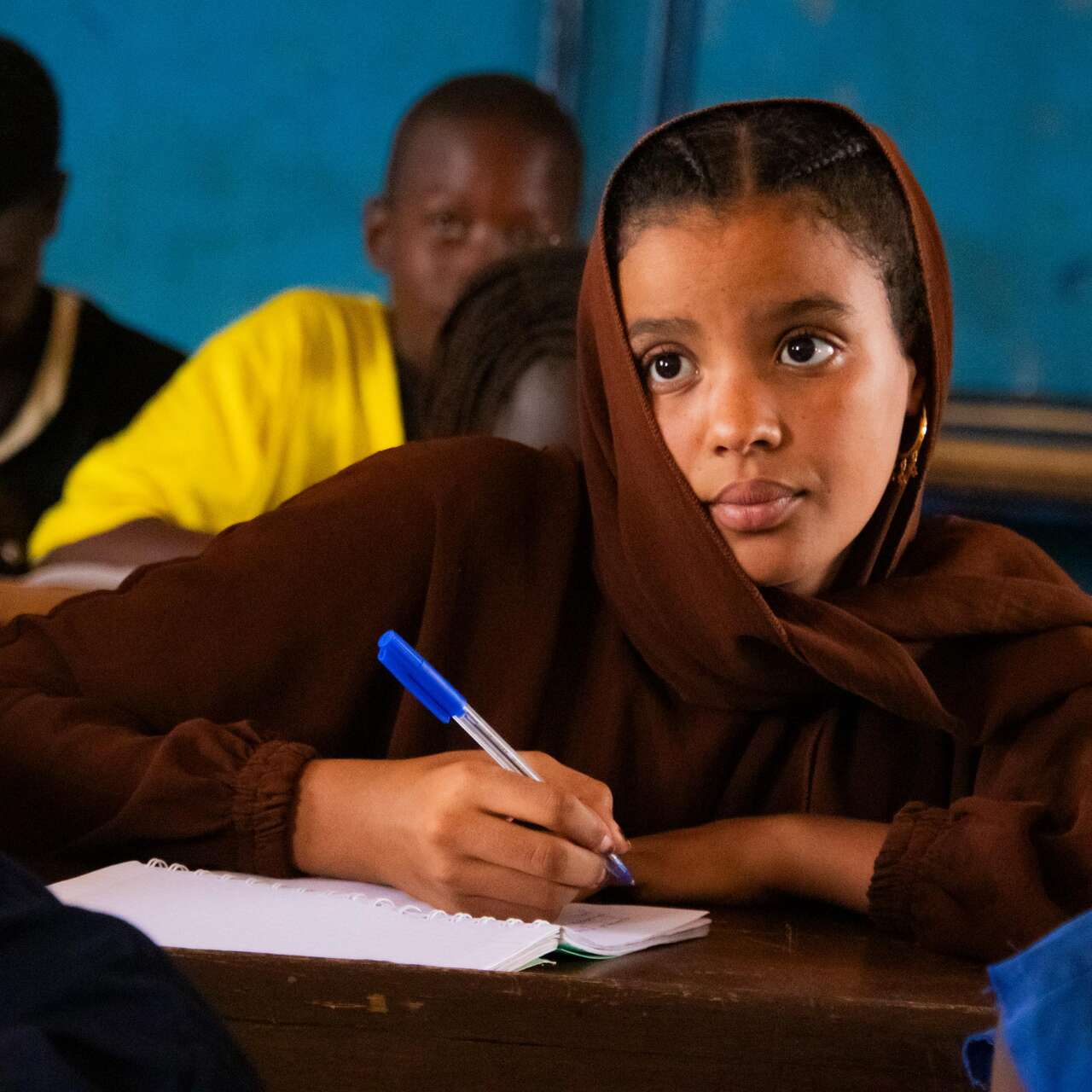 Gao, Mali. Samah, 15, looking at the blackboard while writing.