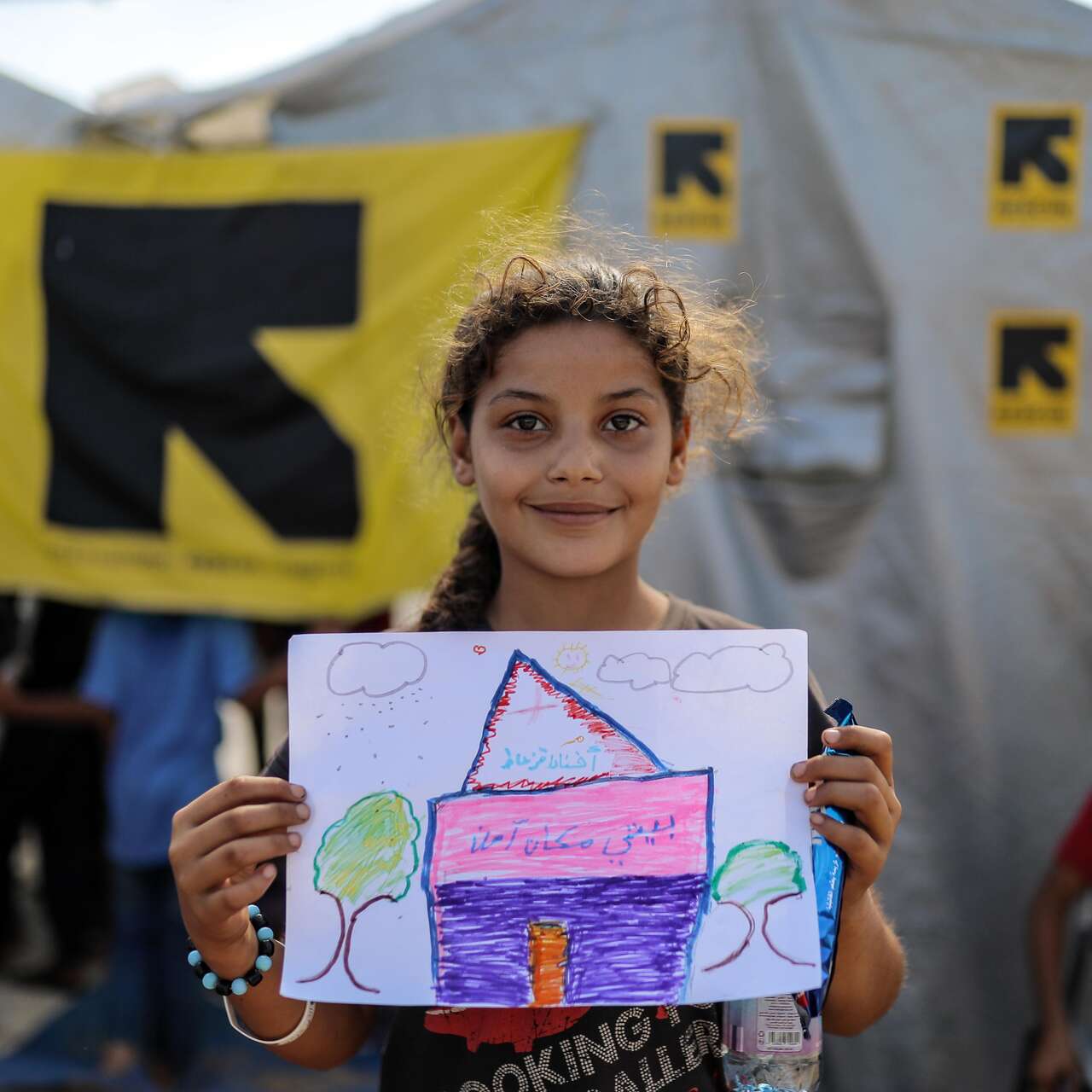 child showing the picture she has drawn 