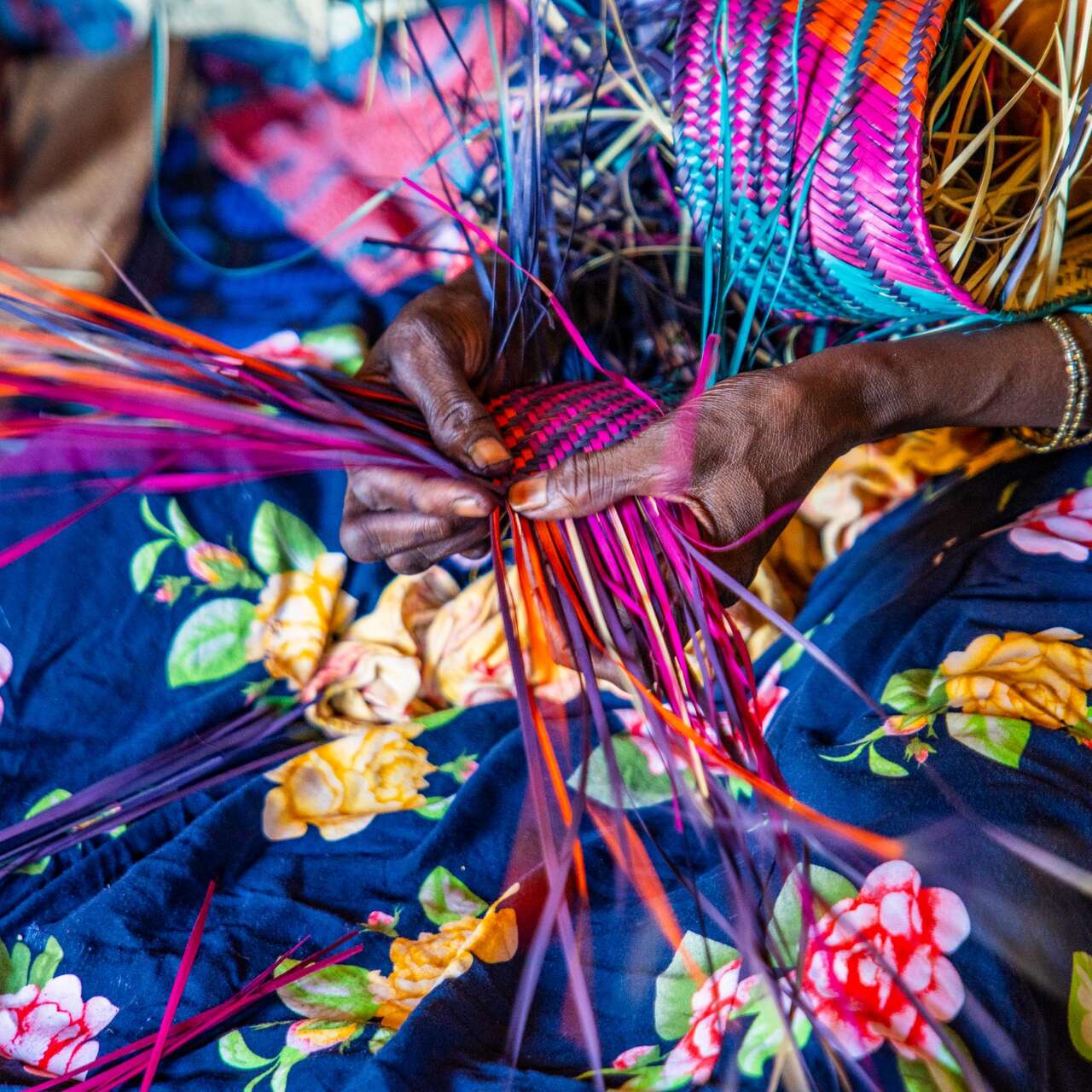 Women weaving a mat. 