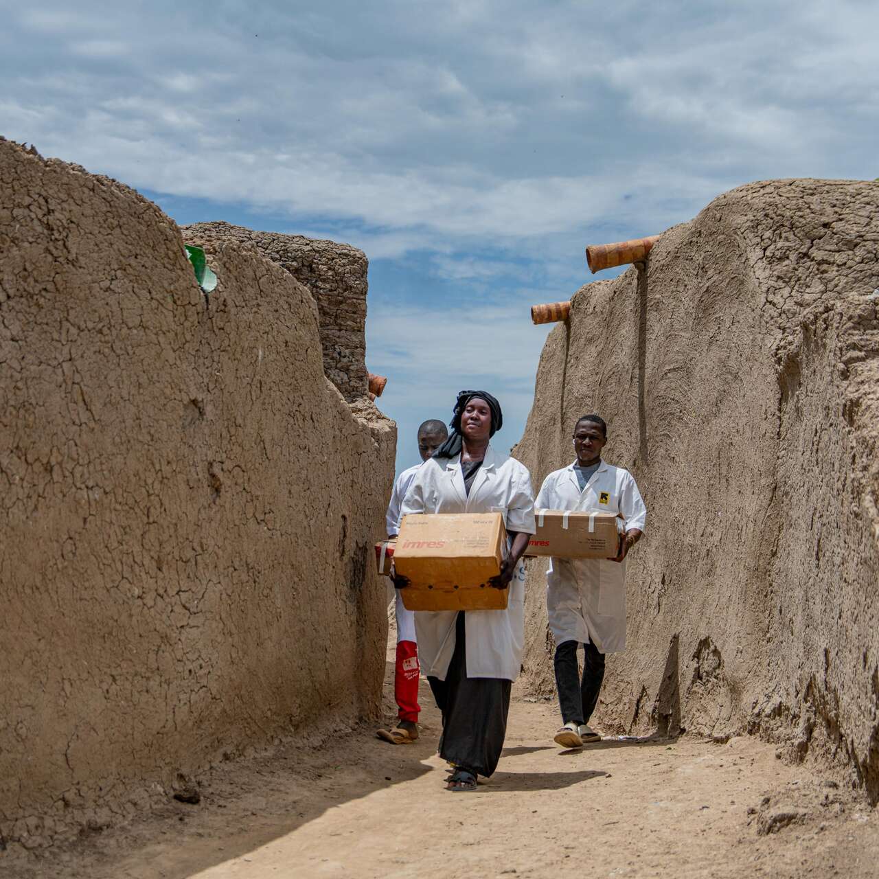 People walking with boxes 