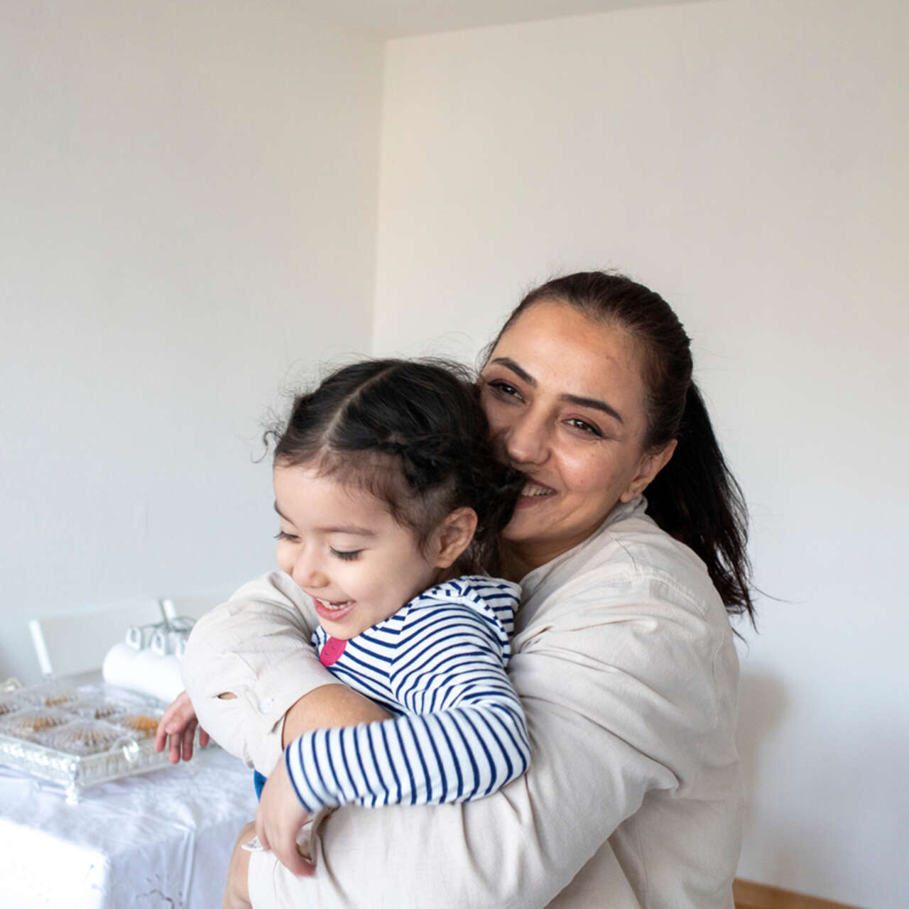 Bahar* is playing with her daughter Mina* in her new apartment in Berlin.