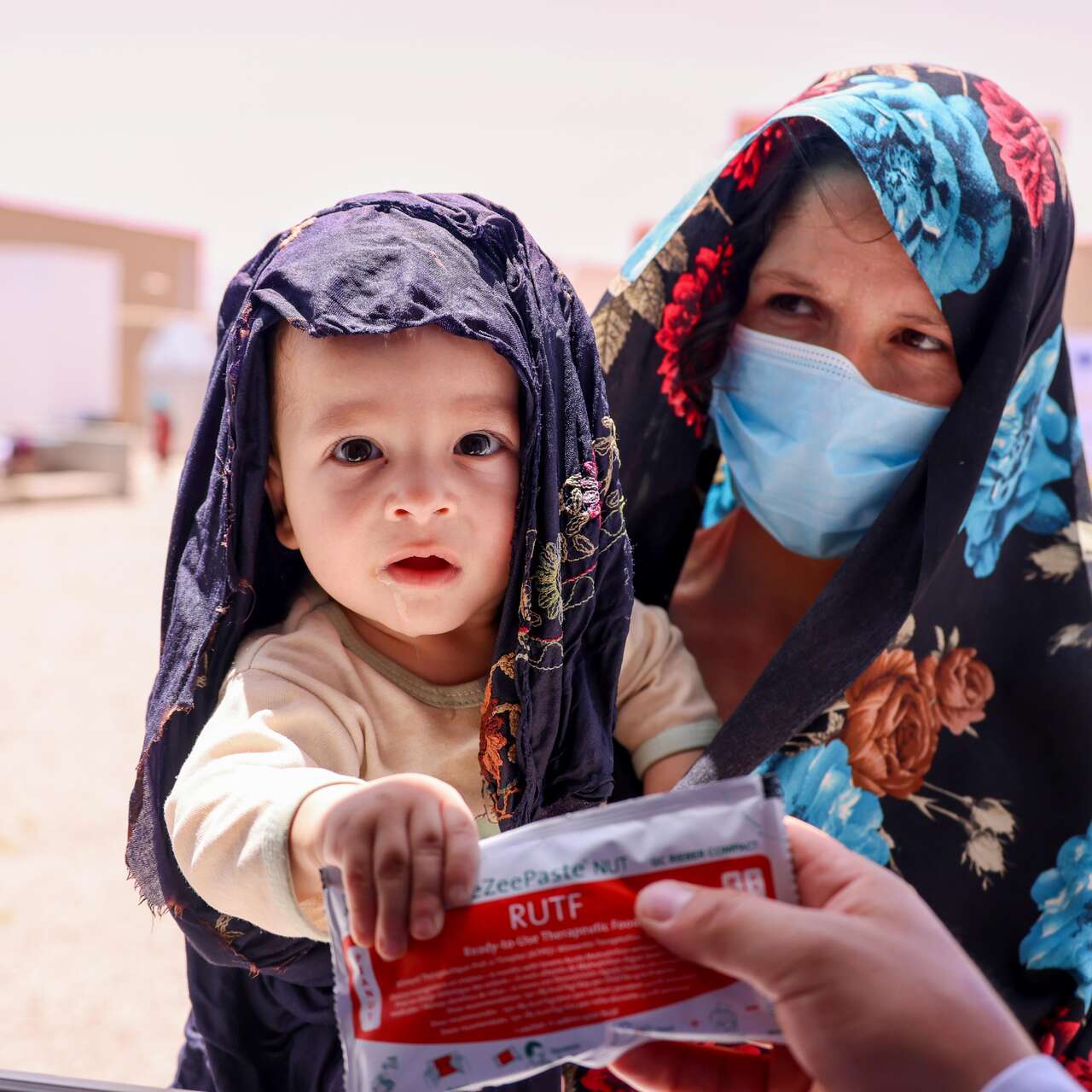 A packet of ready-to-use therapeutic food (RUTF) is given to Sahil and his mother Afsana at the IRC’s EU-supported health facility, during their follow up appointment.