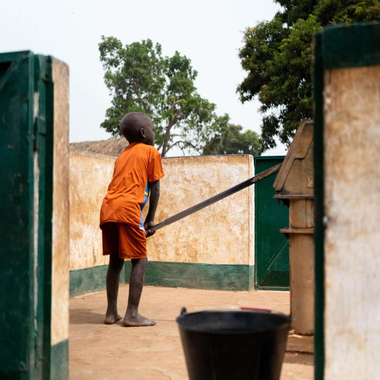 A child from the village uses the well.