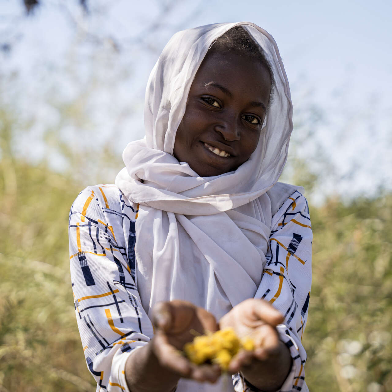 Girl holds flowers to the camera