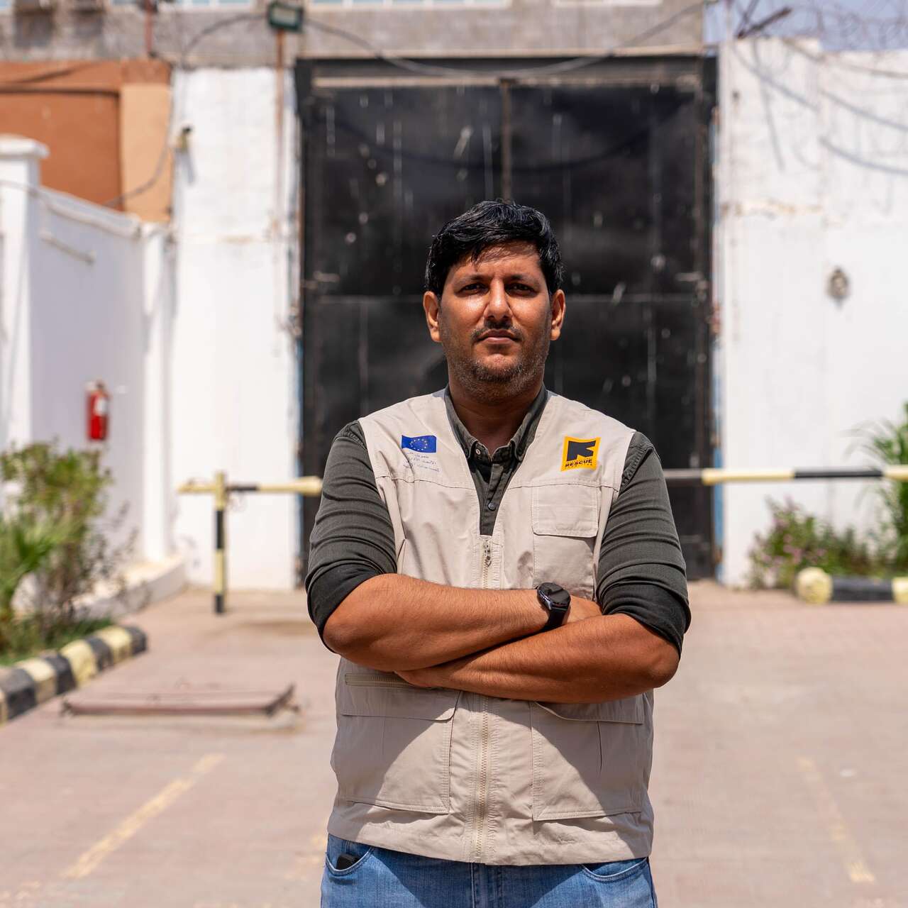 Dr Ahmed, arms crossed, looking at the camera. 