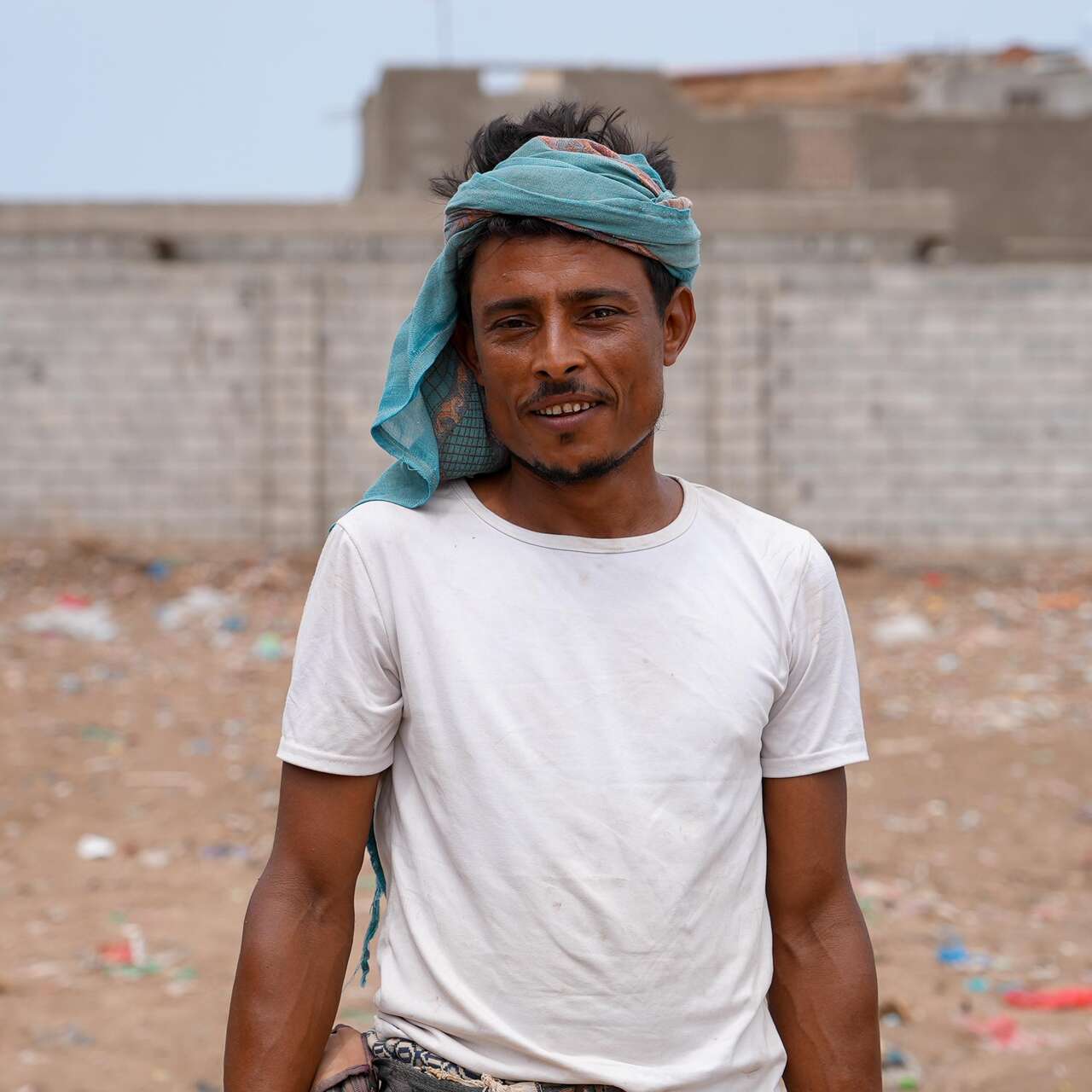 Ahmed, father of four, near a shelter he has built for his family after being displaced six years ago.