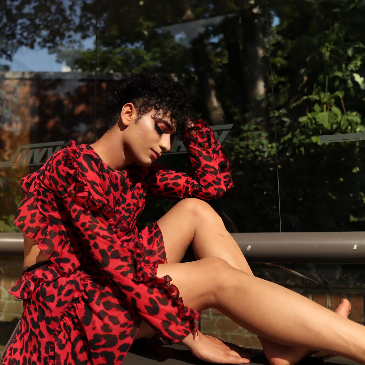 Najib Faizi dressed in a red dress