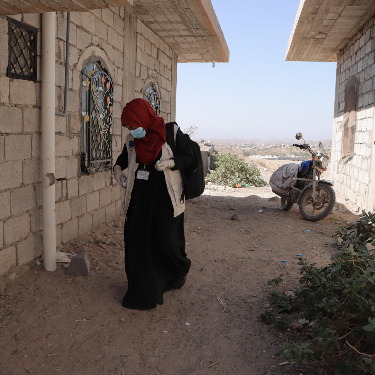Dr. Bushra walking in a remote village in Yemen, where she travels with an IRC mobile medical team to provide reproductive health care to women.