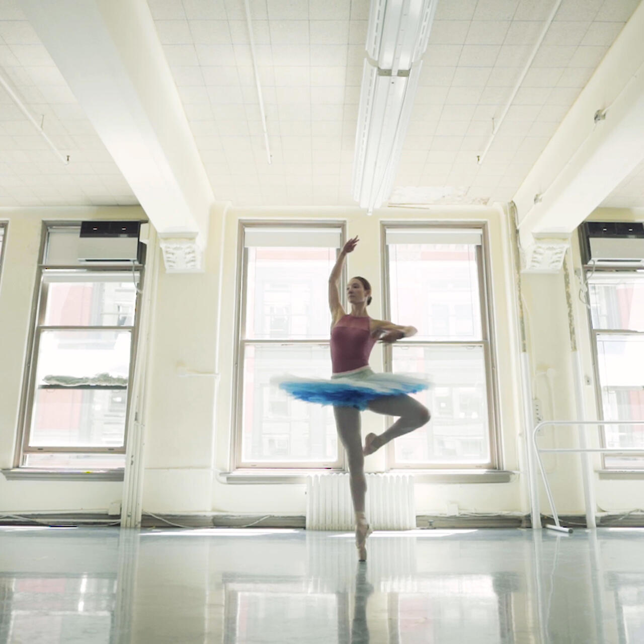 Ballerina Christine dancing in a studio.